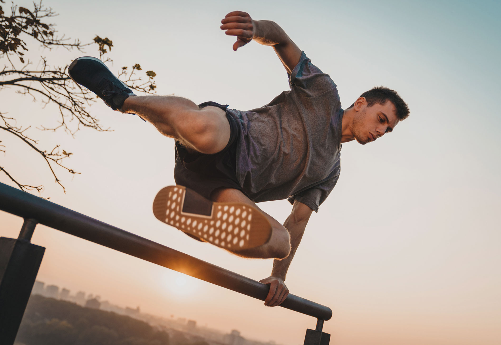 man jumping over pole