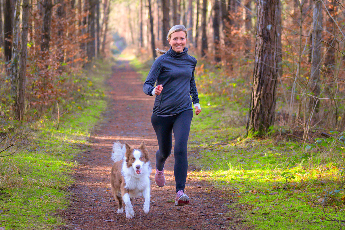 woman on a run with her dog
